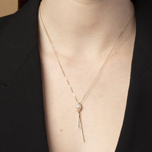 Tick & Tack Halsband i 14K Guld – bärs av kvinna med svart kavaj, poetisk och rytmisk design.